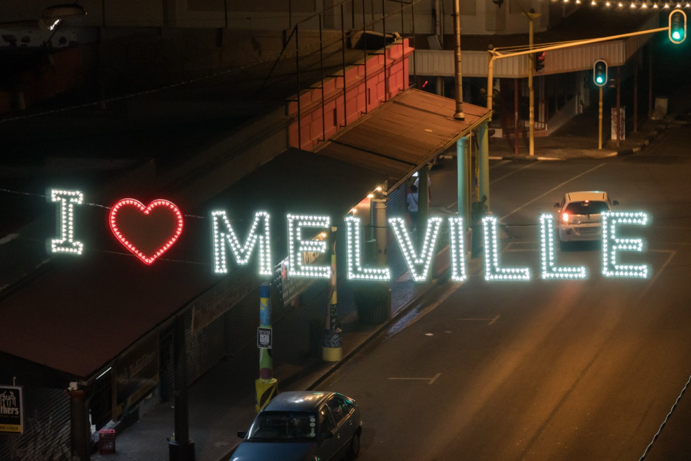 The I ❤ Melville lights glowing over 7th Street at night